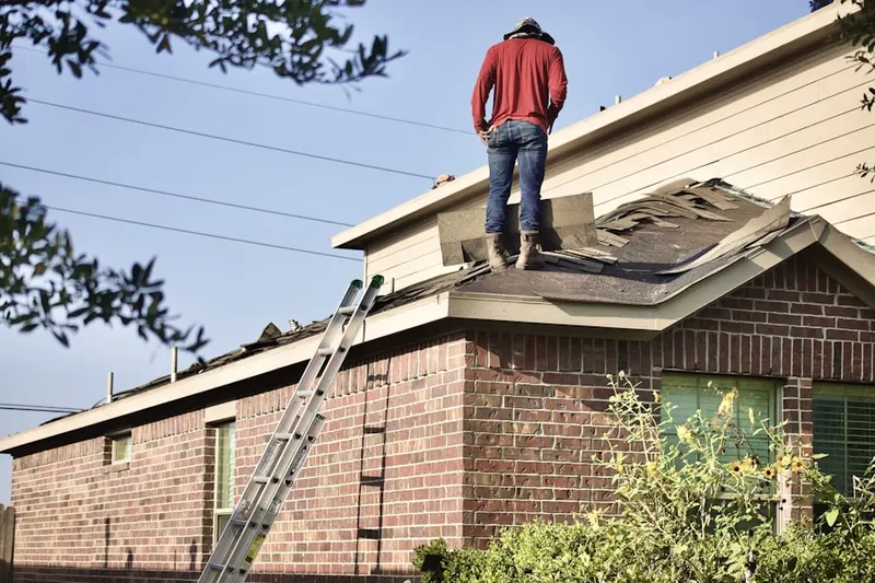 Professional roofer working on a residential roof in Roslyn Heights